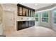 Bright dining area with custom black cabinetry, marble countertops and built-in glass shelving and oversized window at 400 Walnut Grove Rd, Peachtree City, GA 30269
