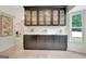 Bright dining area with custom black cabinetry, marble countertops and built-in glass shelving and oversized window at 400 Walnut Grove Rd, Peachtree City, GA 30269