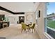 Bright dining area featuring a round table, green chairs, and a view of the fireplace and front yard at 400 Walnut Grove Rd, Peachtree City, GA 30269