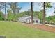 View of the home, attached garage, and green lawn at 400 Walnut Grove Rd, Peachtree City, GA 30269