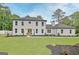 Exterior view of a two story home with a manicured front lawn, beautiful landscaping, and a grey roof at 400 Walnut Grove Rd, Peachtree City, GA 30269