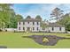 Stunning white-brick two-story home featuring a well-manicured lawn and tasteful landscaping at 400 Walnut Grove Rd, Peachtree City, GA 30269