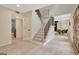 Light-filled foyer with stairs, dining area views, and access to a modern bathroom at 400 Walnut Grove Rd, Peachtree City, GA 30269