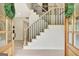 View through the front doorway of a foyer with a modern staircase featuring black metal rails at 400 Walnut Grove Rd, Peachtree City, GA 30269