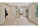 Spacious foyer with a staircase, light hardwood floors, and a view of the dining and kitchen areas at 400 Walnut Grove Rd, Peachtree City, GA 30269