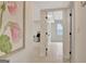 Hallway with white walls and hardwood floors leading to a bedroom, decorated with a flower print at 400 Walnut Grove Rd, Peachtree City, GA 30269
