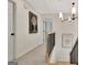 Second floor hallway with staircase, carpet, and modern chandelier at 400 Walnut Grove Rd, Peachtree City, GA 30269
