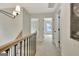 Hallway with neutral carpeting, a modern chandelier, and access to bedrooms at 400 Walnut Grove Rd, Peachtree City, GA 30269