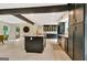 Open concept kitchen with island, stainless appliances and custom cabinets that opens to living spaces at 400 Walnut Grove Rd, Peachtree City, GA 30269