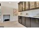Modern kitchen with black cabinets, marble countertops, stainless steel appliances, and a decorative backsplash at 400 Walnut Grove Rd, Peachtree City, GA 30269