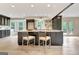 Modern kitchen featuring a central island with seating, dark cabinets, and stainless steel appliances at 400 Walnut Grove Rd, Peachtree City, GA 30269