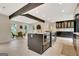 Open concept kitchen with large island, stainless oven and view of dining and living spaces at 400 Walnut Grove Rd, Peachtree City, GA 30269