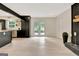 Open-concept living area featuring a fireplace, hardwood floors, and double doors leading to the backyard at 400 Walnut Grove Rd, Peachtree City, GA 30269