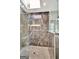 Close up of a modern glass shower with rainfall shower head, bench, and recessed shelf at 400 Walnut Grove Rd, Peachtree City, GA 30269