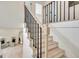 Staircase with white risers and black iron spindles leads up to the second floor at 400 Walnut Grove Rd, Peachtree City, GA 30269
