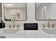 Close up of a double vanity with stone countertop and modern fixtures at 400 Walnut Grove Rd, Peachtree City, GA 30269