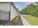 The side yard of this home has been freshly landscaped with black mulch and green shrubbery at 400 Walnut Grove Rd, Peachtree City, GA 30269