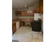 Functional kitchen with wooden cabinets, standard appliances, and lots of potential at 4298 Brookside Dr, Forest Park, GA 30297