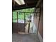 View of rear yard from sunroom needing repair with lattice walls and wood frame at 4298 Brookside Dr, Forest Park, GA 30297