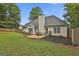 Backyard features lush green lawn, patio, landscaping, and a storage shed at 215 Murphy Creek Ln, Fayetteville, GA 30215