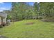 Backyard featuring a lush green lawn and a wooden fence surrounding the perimeter at 215 Murphy Creek Ln, Fayetteville, GA 30215