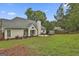 Exterior of home featuring a lush green lawn, landscaping, and shed at 215 Murphy Creek Ln, Fayetteville, GA 30215