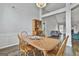 Open dining room with wood table, hardwood floors, and seamless flow to the living room at 215 Murphy Creek Ln, Fayetteville, GA 30215