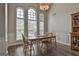 Elegant dining room with large windows, stylish chandelier, and wood flooring at 215 Murphy Creek Ln, Fayetteville, GA 30215