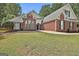 Attractive home with brick exterior, large windows, and well-kept lawn, providing a comfortable and inviting atmosphere at 215 Murphy Creek Ln, Fayetteville, GA 30215