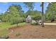 Charming home on a spacious lot with well-maintained landscaping and mature trees providing ample shade at 215 Murphy Creek Ln, Fayetteville, GA 30215