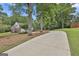 Beautiful home featuring a long driveway, lush lawn, and mature trees creating a private and serene setting at 215 Murphy Creek Ln, Fayetteville, GA 30215
