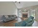 Bright living room featuring a brick fireplace, natural light, and comfortable seating at 215 Murphy Creek Ln, Fayetteville, GA 30215
