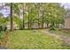Fenced backyard featuring mature trees and grassy lawn at 131 Sweetgum Rd, Peachtree City, GA 30269
