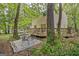 Inviting backyard featuring a wooden deck, patio with furniture, and lush landscaping at 131 Sweetgum Rd, Peachtree City, GA 30269