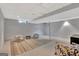 Finished basement space with neutral decor, seating, and a decorative rug at 131 Sweetgum Rd, Peachtree City, GA 30269