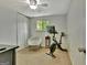 Bedroom features a chair, window, and exercise bike for a multi-purpose space at 131 Sweetgum Rd, Peachtree City, GA 30269