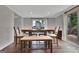 Dining room with a farmhouse table, neutral decor, and natural light streaming in from sliding glass doors at 131 Sweetgum Rd, Peachtree City, GA 30269