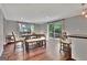 Dining area featuring a large dining table, bench seating, and sliding glass doors to the backyard at 131 Sweetgum Rd, Peachtree City, GA 30269