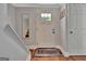 Bright entryway featuring a white front door, wood floors, and a convenient coat closet at 131 Sweetgum Rd, Peachtree City, GA 30269