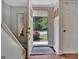 View from the foyer, showcasing the staircase, coat closet, hardwood floors, and an open front door at 131 Sweetgum Rd, Peachtree City, GA 30269