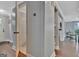 Hallway featuring gray walls, white crown molding and a view to a powder room at 131 Sweetgum Rd, Peachtree City, GA 30269