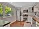 White kitchen features stainless steel appliances and a beautiful view of nature at 131 Sweetgum Rd, Peachtree City, GA 30269