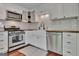 This classic white kitchen has stainless appliances and a farmhouse sink at 131 Sweetgum Rd, Peachtree City, GA 30269