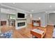 Bright living room with a fireplace, hardwood floors and open to a dining space at 131 Sweetgum Rd, Peachtree City, GA 30269
