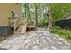 Backyard stone and gravel patio with deck access at 131 Sweetgum Rd, Peachtree City, GA 30269