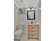 Farmhouse-style powder room featuring a rustic vanity and stylish lighting at 131 Sweetgum Rd, Peachtree City, GA 30269