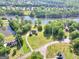 Aerial view of home on 2.75 acres surrounded by lake and trees at 70 Lake Charles Xing, Covington, GA 30016