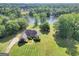 Expansive property with a charming red brick home overlooking a serene lake at 70 Lake Charles Xing, Covington, GA 30016