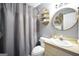 Cozy bathroom featuring a vanity with a sink, toilet, and shower with patterned gray curtain at 70 Lake Charles Xing, Covington, GA 30016