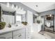 Bathroom showcasing double vanity sinks, a window, decorative plants, and shelving at 70 Lake Charles Xing, Covington, GA 30016